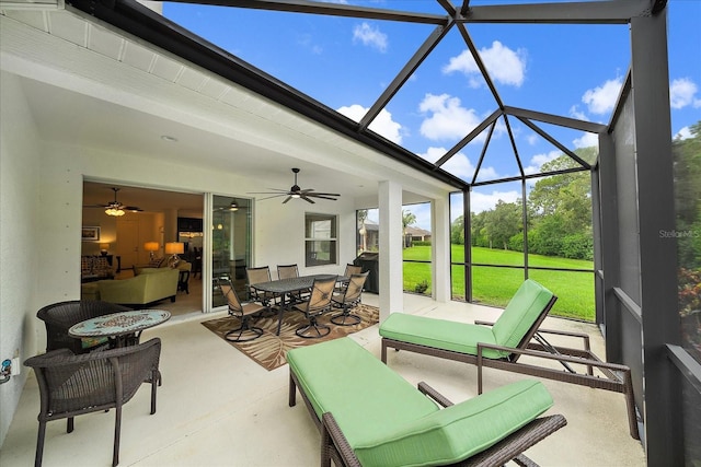 view of patio with ceiling fan, outdoor dining space, outdoor lounge area, and a lanai