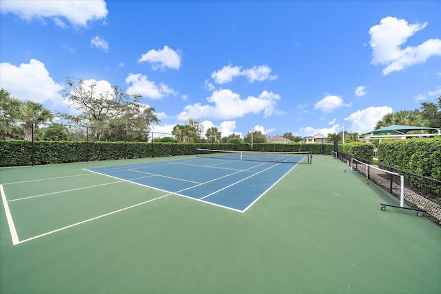 view of tennis court featuring fence