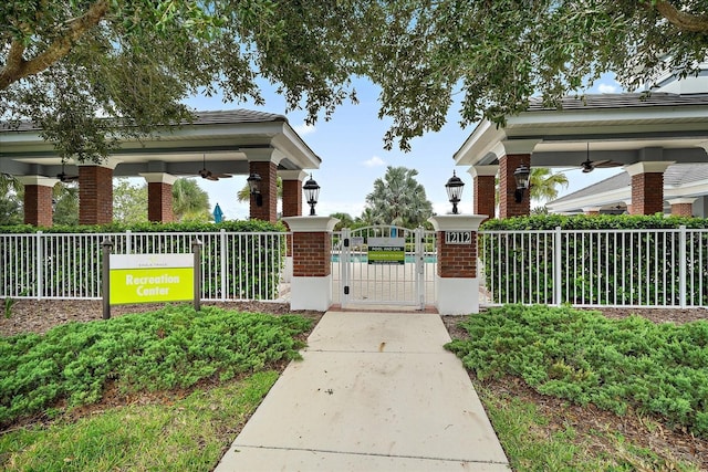 view of home's community featuring fence and a gate