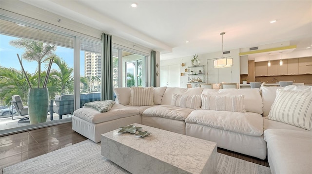 living area featuring recessed lighting and visible vents