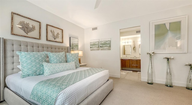 bedroom featuring baseboards, visible vents, connected bathroom, and carpet flooring