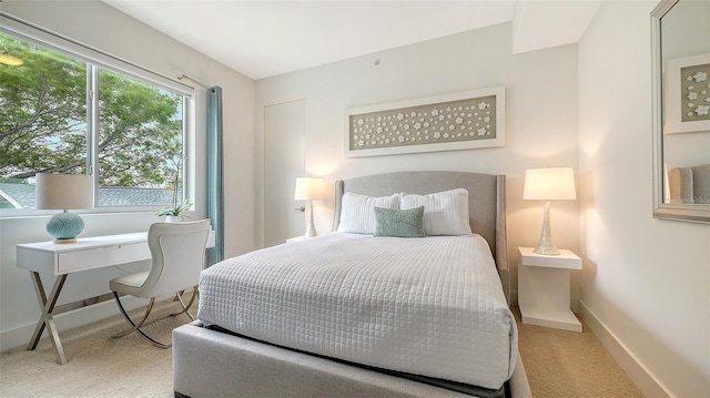 carpeted bedroom featuring baseboards