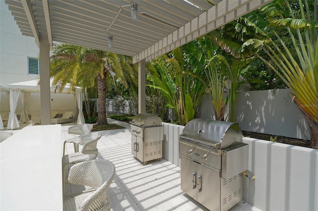 view of patio / terrace with fence, grilling area, a pergola, and area for grilling