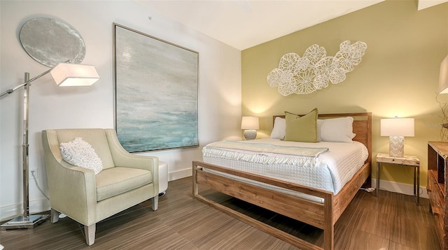 bedroom with wood finished floors and baseboards