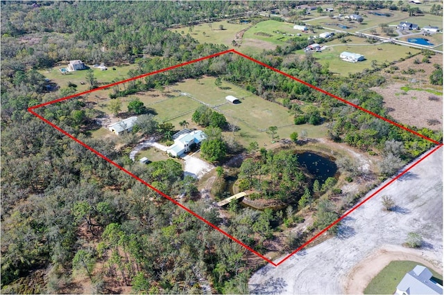 birds eye view of property with a rural view