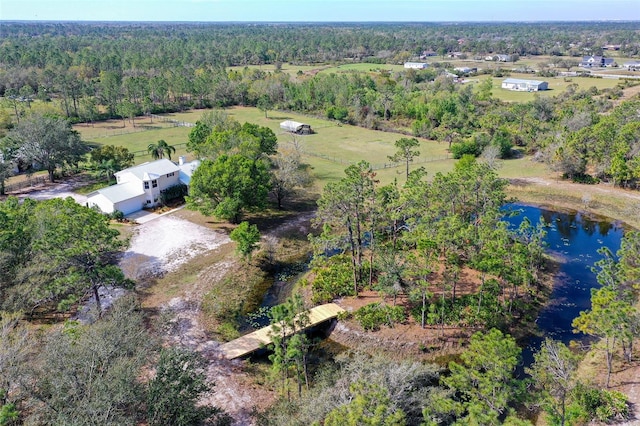 drone / aerial view featuring a forest view