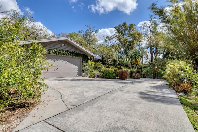 view of home's exterior with a garage and concrete driveway