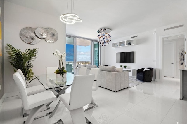 dining area featuring a wall of windows, visible vents, a notable chandelier, and light tile patterned flooring