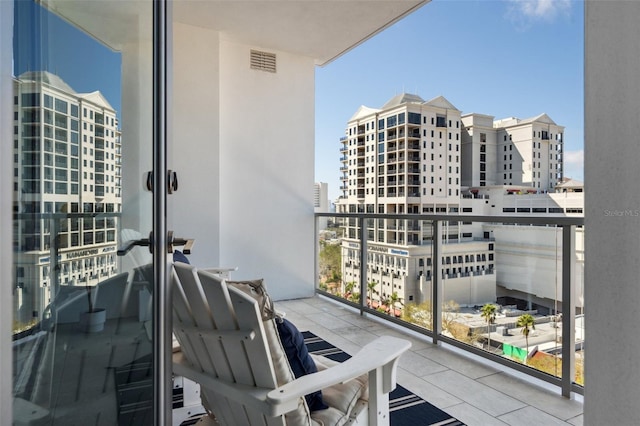 balcony with visible vents and a city view