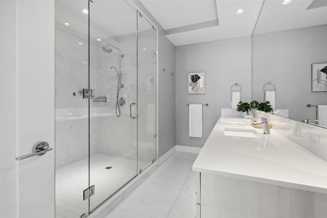 full bathroom featuring double vanity, a marble finish shower, marble finish floor, a sink, and recessed lighting