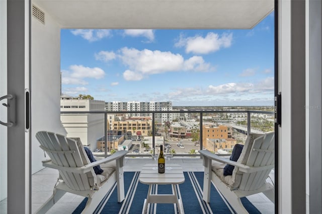 balcony with a view of city and visible vents