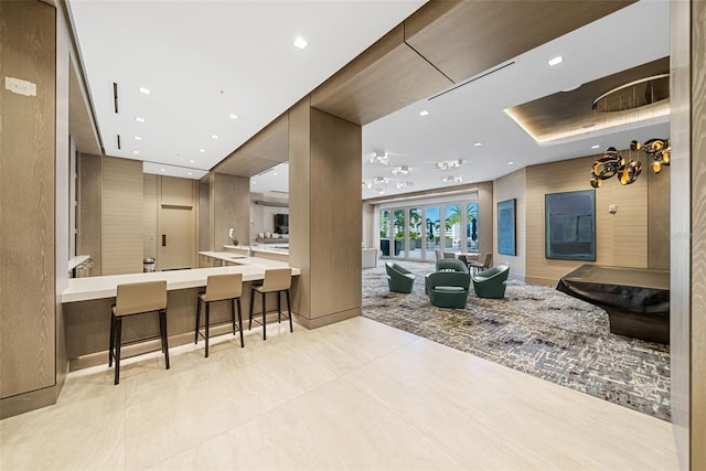 interior space featuring modern cabinets, a breakfast bar area, open floor plan, a peninsula, and recessed lighting