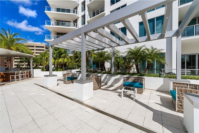 view of patio with outdoor dry bar and a pergola