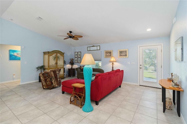 living room featuring visible vents, baseboards, ceiling fan, vaulted ceiling, and light tile patterned floors