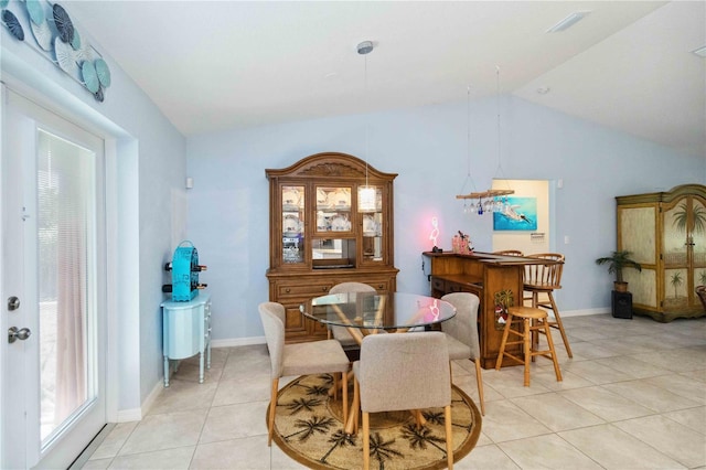 dining space featuring vaulted ceiling, light tile patterned flooring, baseboards, and visible vents