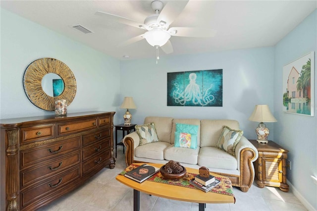 living room with light tile patterned flooring, baseboards, visible vents, and ceiling fan