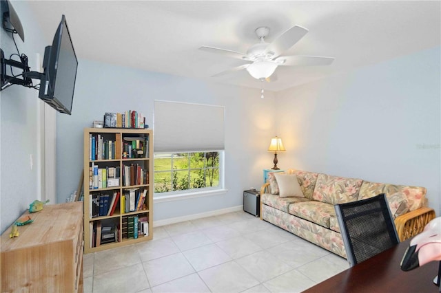 tiled living room with baseboards and ceiling fan