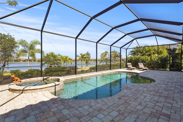 view of swimming pool featuring a patio area, a pool with connected hot tub, a lanai, and a water view