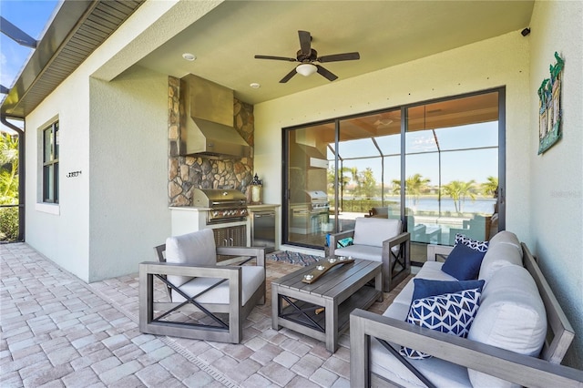 view of patio featuring a lanai, grilling area, an outdoor hangout area, and exterior kitchen