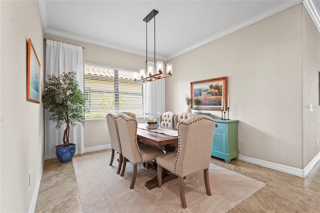 dining room with a chandelier, baseboards, and ornamental molding