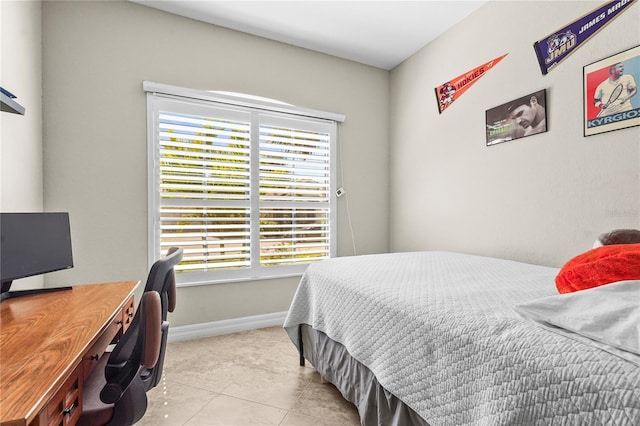 bedroom with tile patterned floors and baseboards