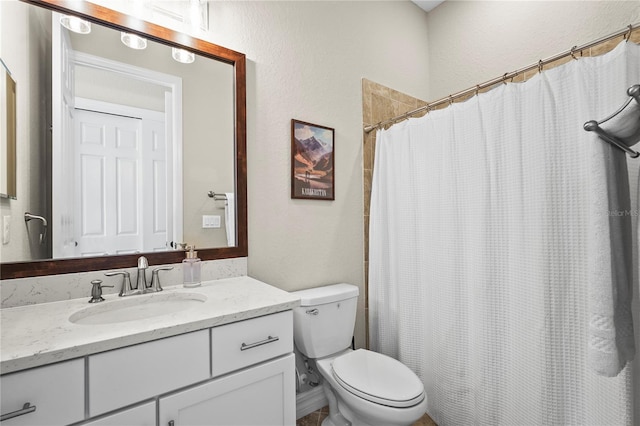 full bathroom with vanity, curtained shower, toilet, and a textured wall