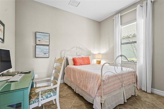 bedroom with tile patterned floors, visible vents, and baseboards