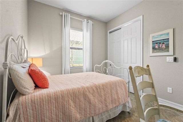 bedroom with baseboards and a closet