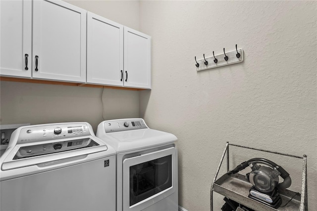 laundry room featuring cabinet space and washing machine and clothes dryer