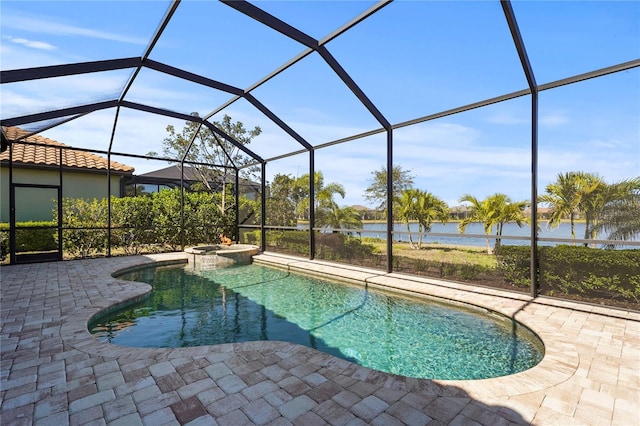 view of swimming pool with glass enclosure, a patio, a water view, and a pool with connected hot tub