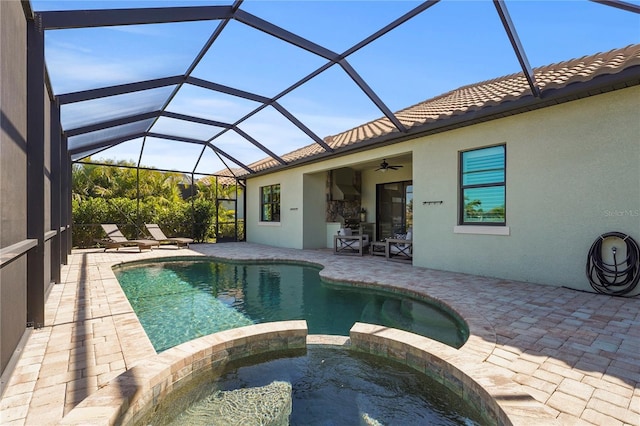 view of pool featuring a patio, a lanai, a pool with connected hot tub, and ceiling fan