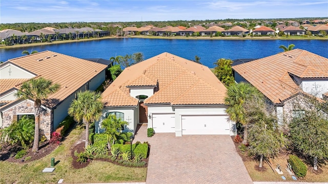 drone / aerial view featuring a residential view and a water view