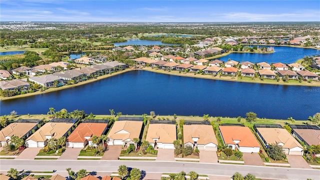 drone / aerial view with a residential view and a water view