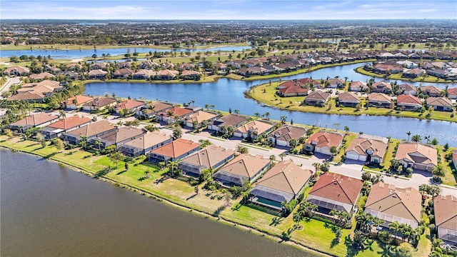 drone / aerial view with a residential view and a water view