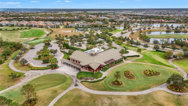 drone / aerial view with golf course view, a water view, and a residential view