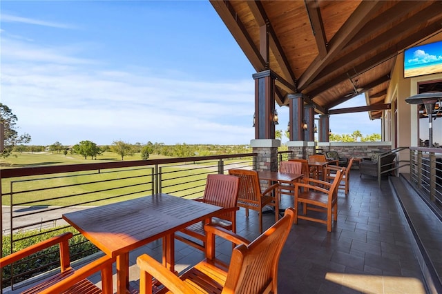 view of patio / terrace featuring a balcony and outdoor dining space