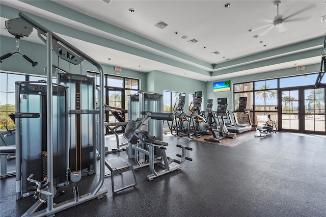 gym with visible vents, ceiling fan, and french doors