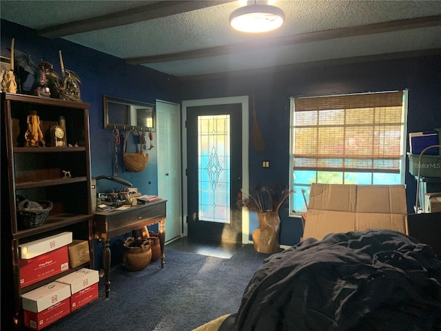 carpeted bedroom featuring a textured ceiling