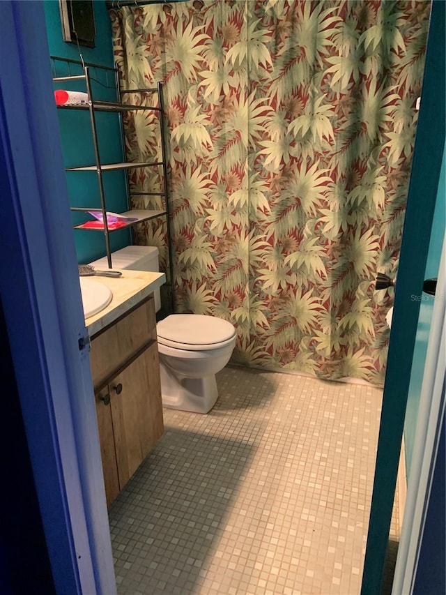 full bathroom featuring wallpapered walls, vanity, toilet, and tile patterned floors