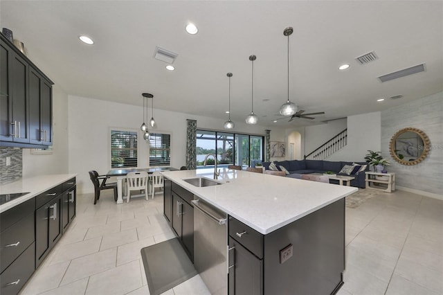 kitchen with a sink, pendant lighting, visible vents, and dishwasher