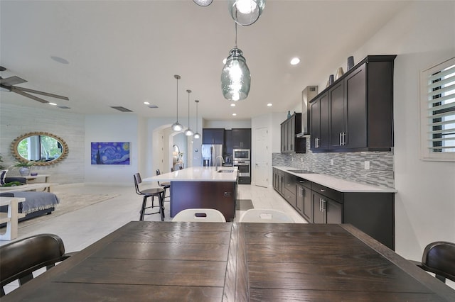 dining space with a ceiling fan and recessed lighting