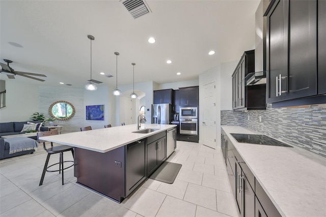 kitchen featuring a sink, backsplash, open floor plan, stainless steel appliances, and visible vents