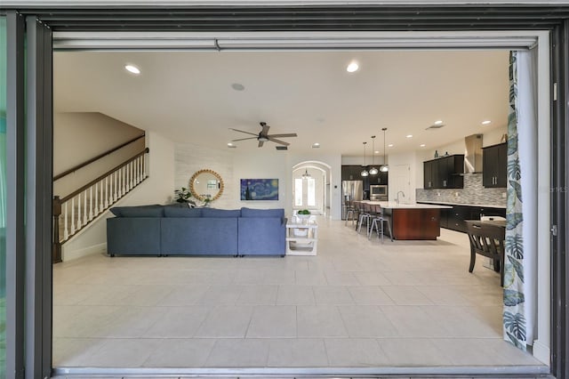 living room with recessed lighting, stairway, and a ceiling fan