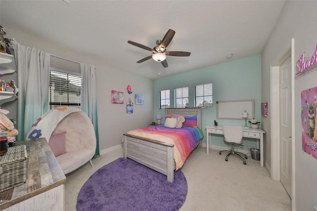 carpeted bedroom with baseboards and a ceiling fan