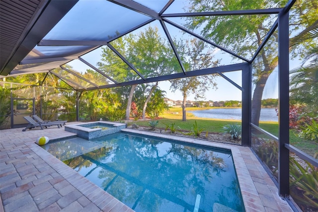 view of swimming pool featuring glass enclosure, a water view, a pool with connected hot tub, and a patio area