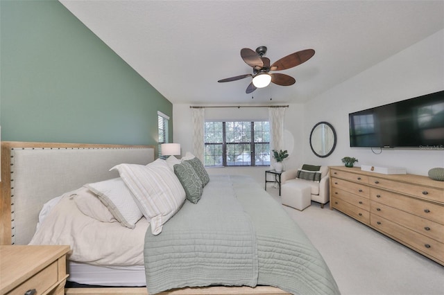 carpeted bedroom featuring a ceiling fan and lofted ceiling