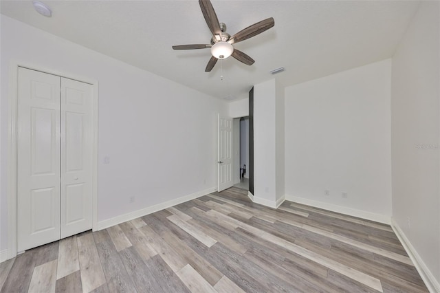 unfurnished bedroom with visible vents, baseboards, ceiling fan, and light wood-type flooring