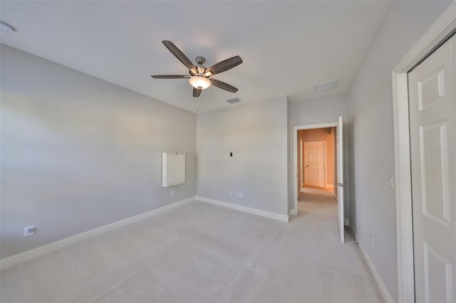 unfurnished bedroom featuring ceiling fan, baseboards, light colored carpet, and visible vents