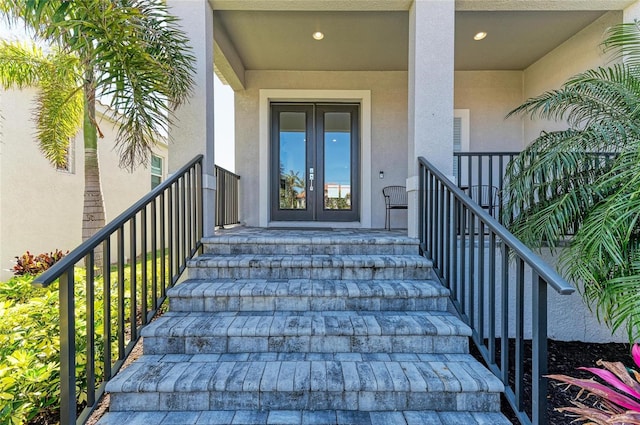 entrance to property with french doors and stucco siding