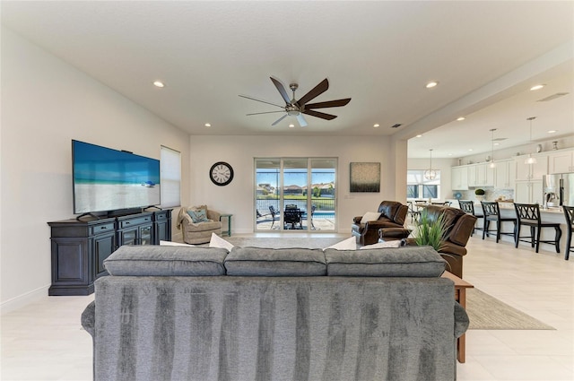 living room featuring recessed lighting, ceiling fan, and baseboards